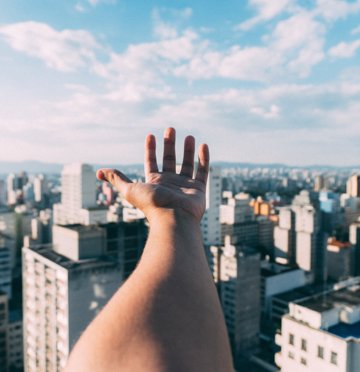 Hand above buildings